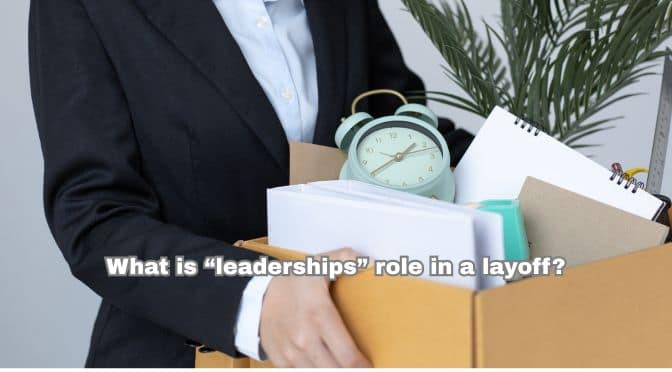 An employee carrying a box of personal things as they are leaving work after a layoff.